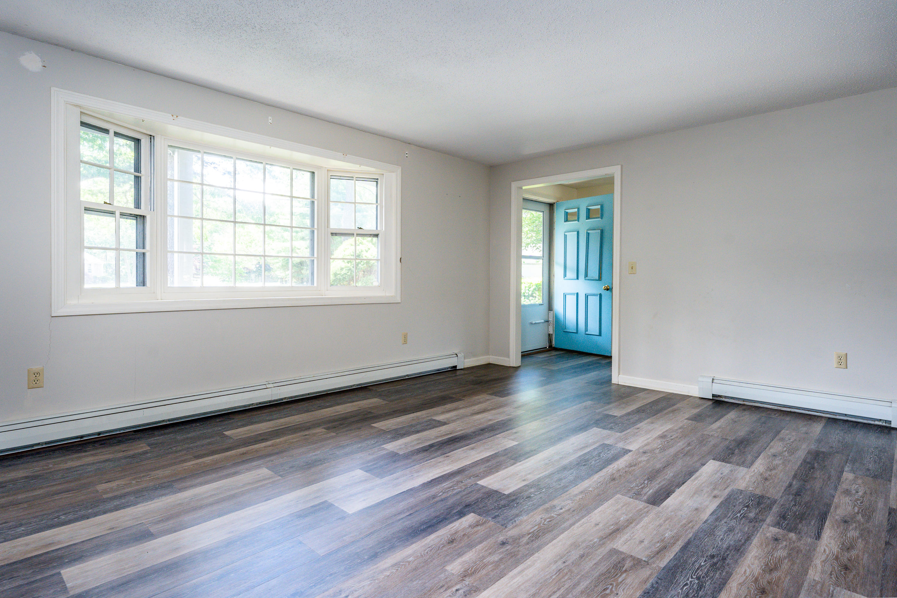 7 Rolling Hitch Road Centerville, MA 02632 - Photo 5 of 19 an empty room with wooden floor and windows