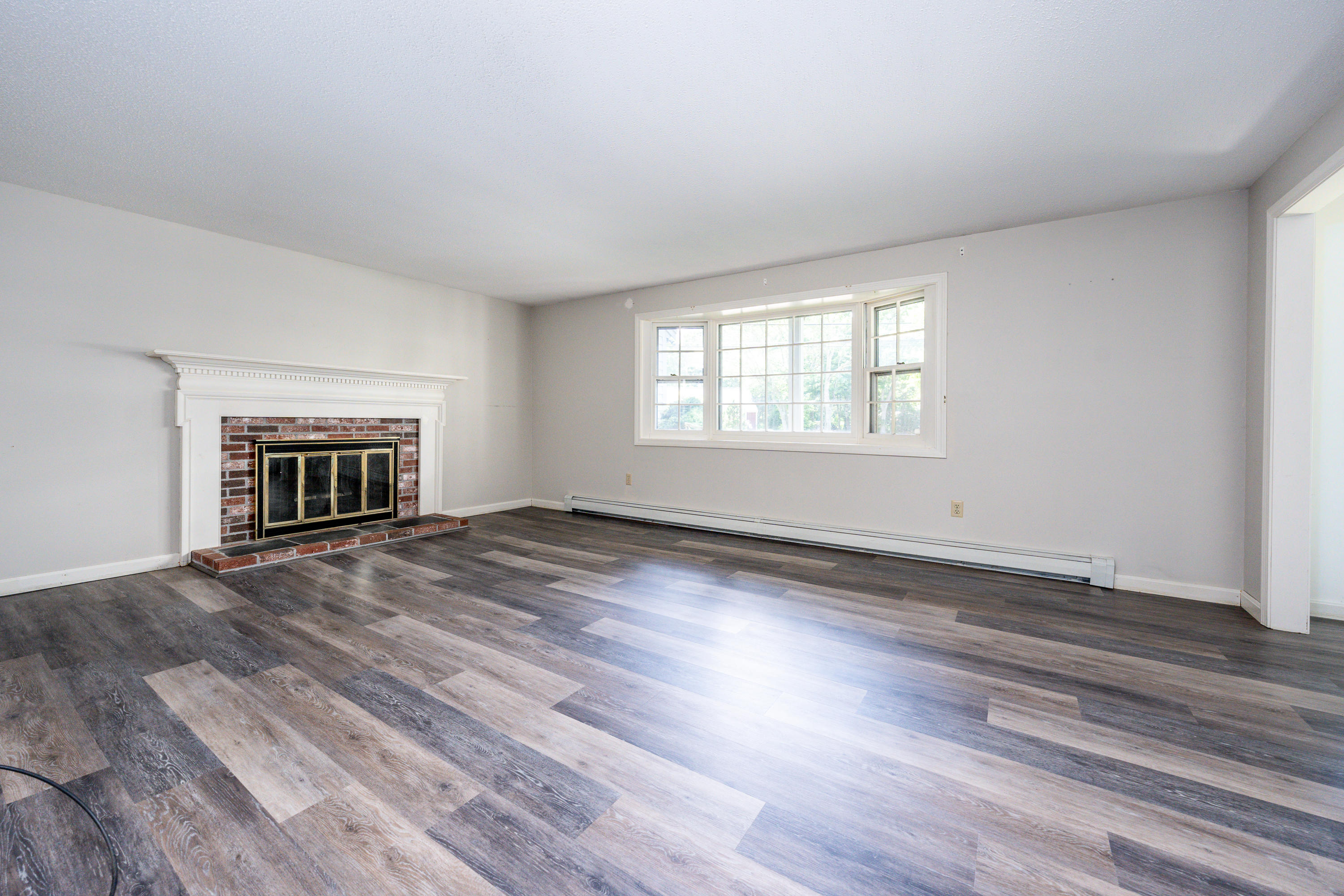 7 Rolling Hitch Road Centerville, MA 02632 - Photo 6 of 19 an empty room with wooden floor cabinet and windows