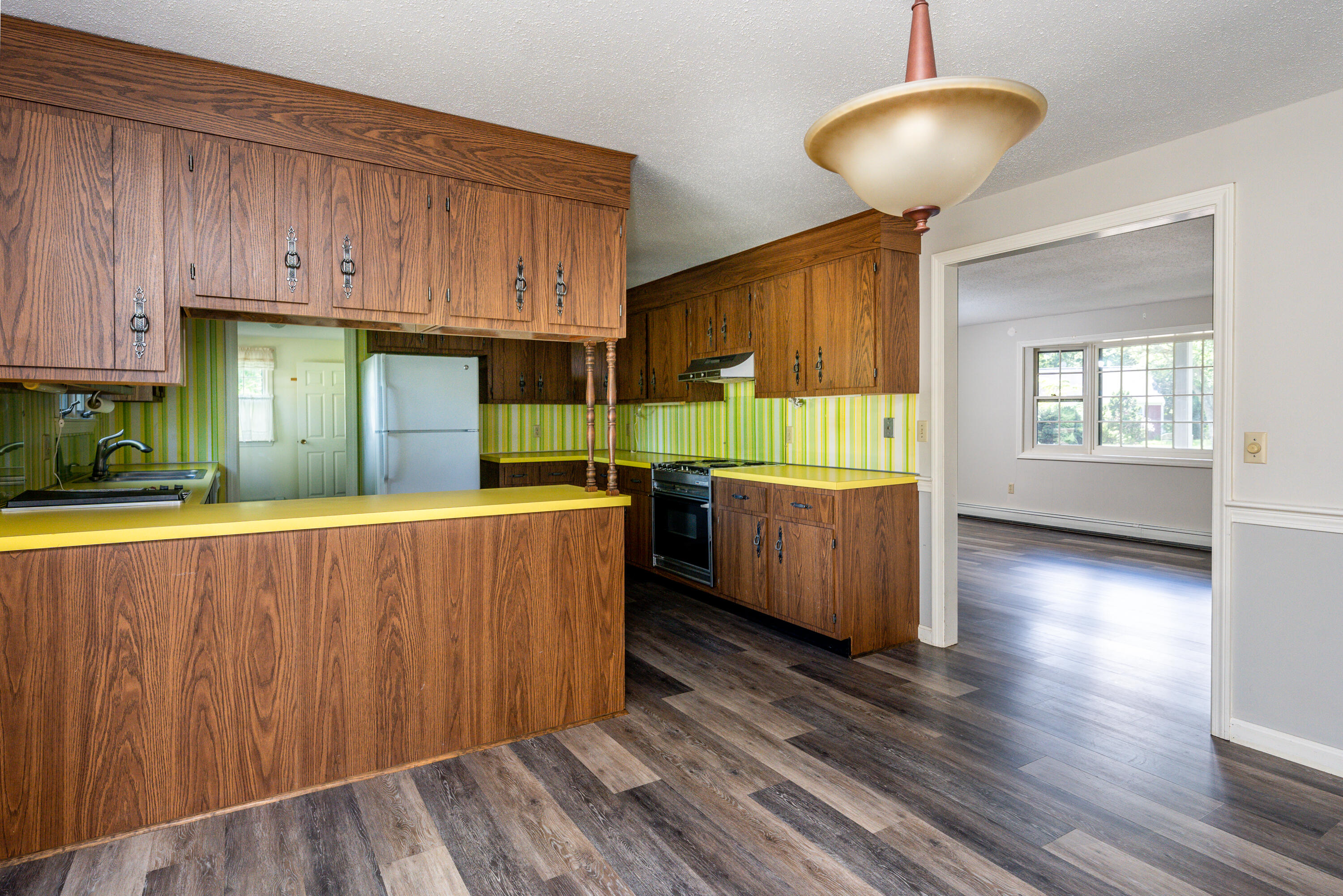 7 Rolling Hitch Road Centerville, MA 02632 - Photo 9 of 19 a kitchen with kitchen island wooden floors and wooden cabinets