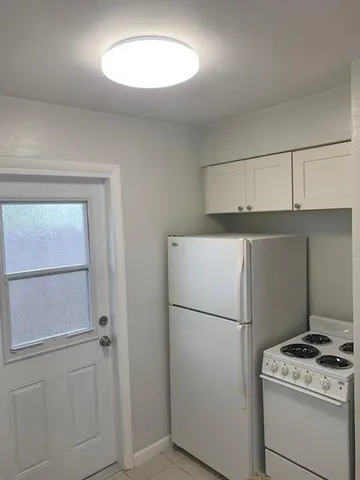 a kitchen with a refrigerator and a stove