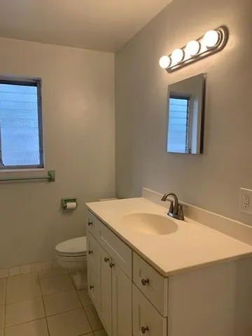 a bathroom with a sink a toilet and mirror