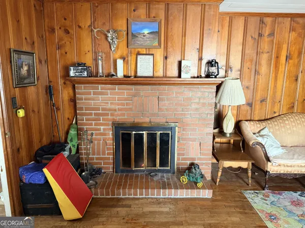 a living room with furniture a flat screen tv and a dining table