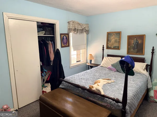 a bedroom with a bed and a television