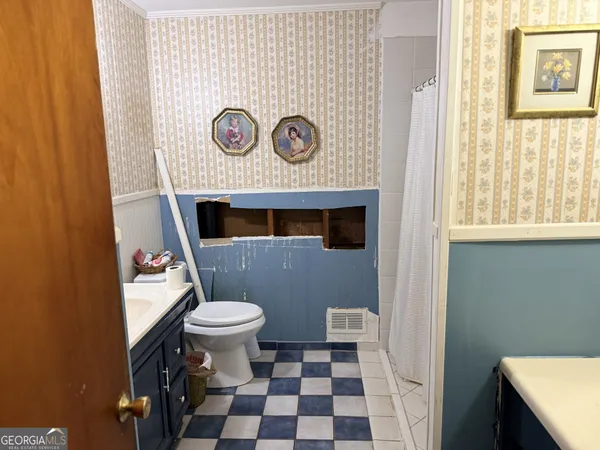 a bedroom with a bed and a flat tv screen