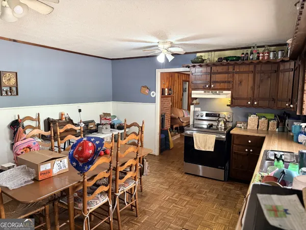 a kitchen with a table chairs and wooden cabinets
