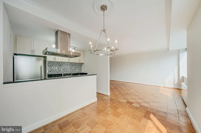 a kitchen with kitchen island granite countertop a sink a counter space and cabinets