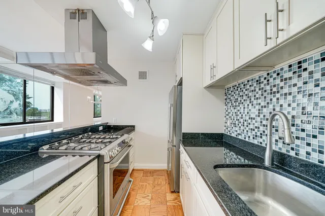 a kitchen with a stove a sink and a refrigerator