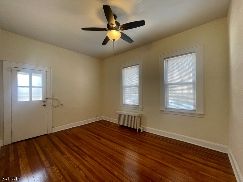 139 Ray Street, Unit 2 Garfield, NJ 07026 - Photo 5 of 11 a view of an empty room with wooden floor and a window