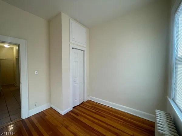 a view of room with wooden floor