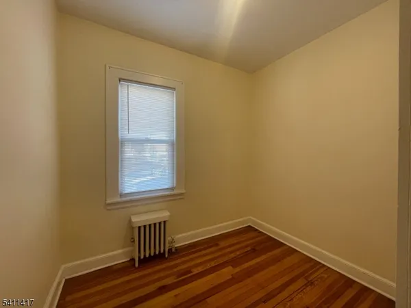 a view of room with window and wooden floor