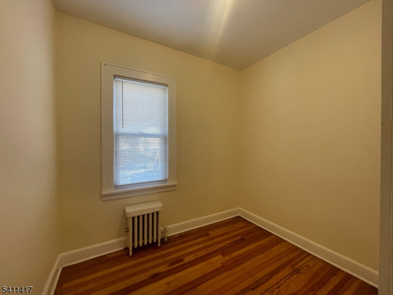 139 Ray Street, Unit 2 Garfield, NJ 07026 - Photo 9 of 11 a view of room with window and wooden floor