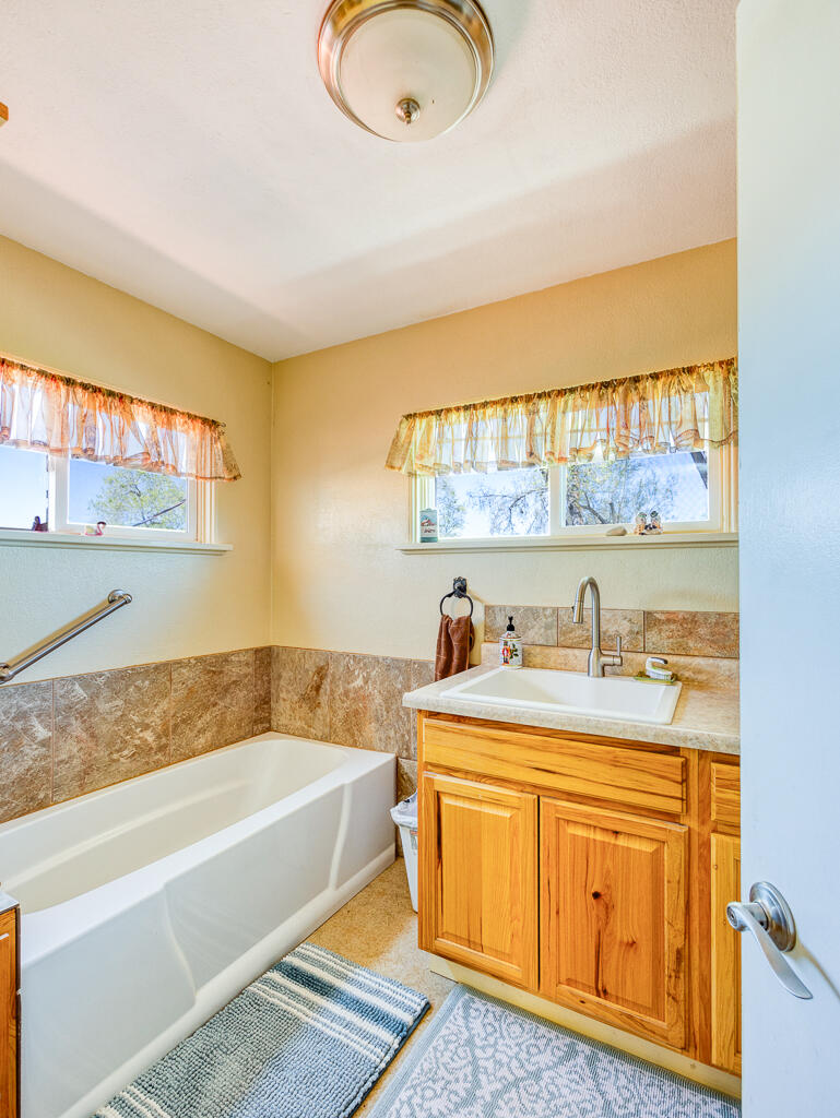 4650 Lower Klamath Lake Road Klamath Falls, OR 97603 - Photo 18 of 37 a bathroom with a granite countertop sink and a bathtub