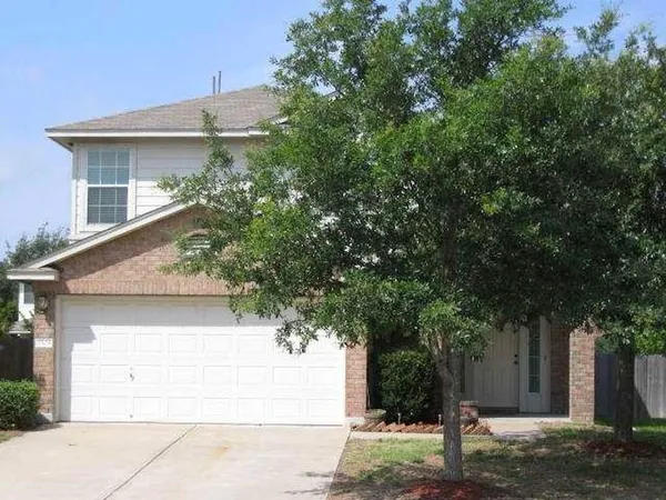 a view of a house with a tree