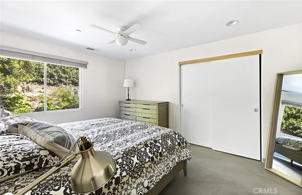 a bedroom with a bed and a window