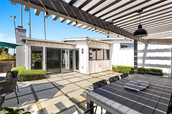 a view of a patio with table and chairs and wooden floor