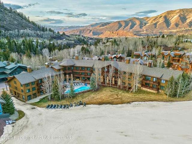 an aerial view of residential houses with outdoor space and street view