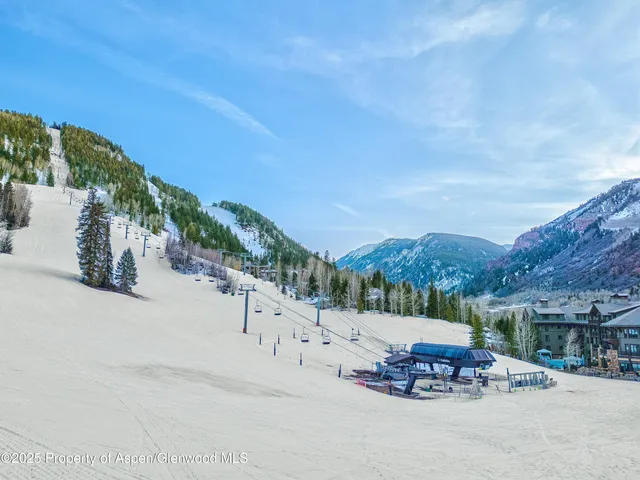a view of a road with a bench in front of house