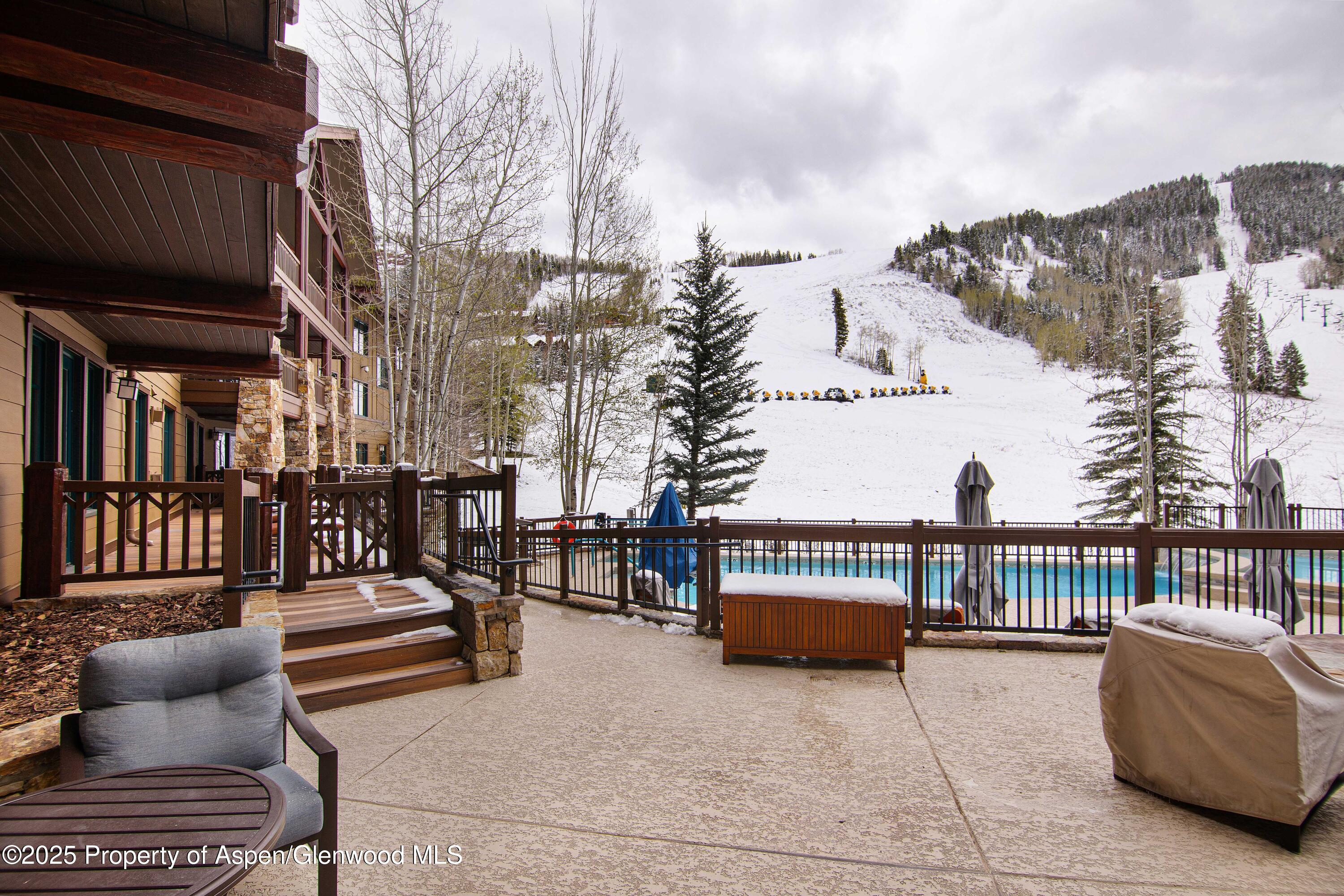197 Prospector Road, Unit 2307SUMMER 12 Aspen, CO 81611 - Photo 6 of 18 a roof deck with couches and wooden floor