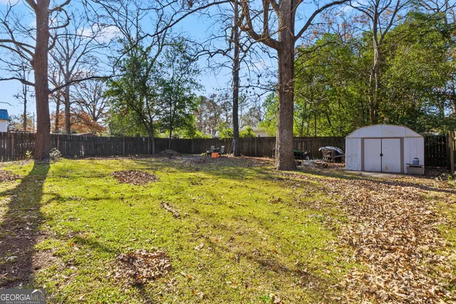 a swimming pool with outdoor seating and yard