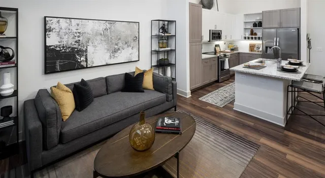 a living room with furniture and a painting on the wall