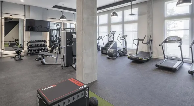 a room with gym equipment and a window
