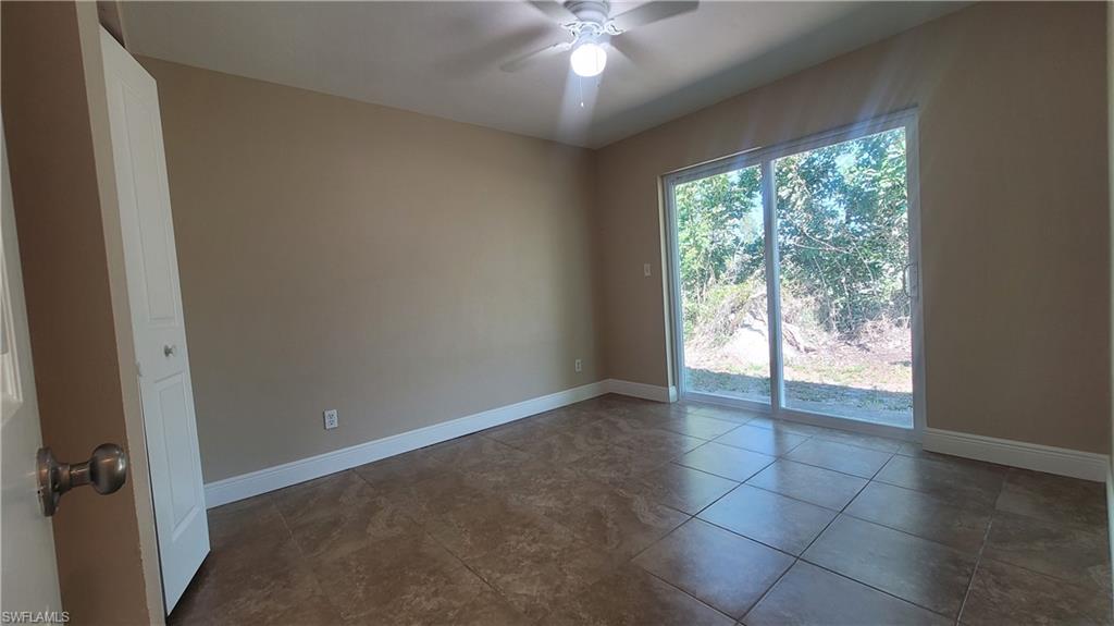 7504-7508 Pebble Beach Road Fort Myers, FL 33967 - Photo 4 of 13 an empty room with windows and outdoor view