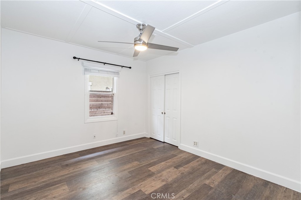 415 7th Street Paso Robles, CA 93446 - Photo 13 of 21 an empty room with wooden floor ceiling fan and window