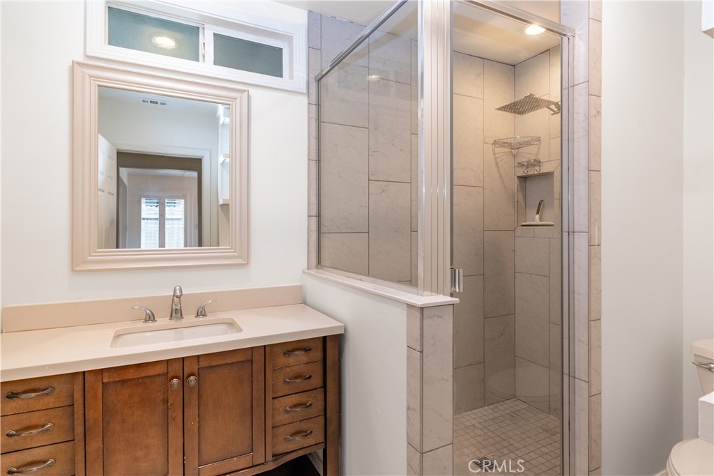 415 7th Street Paso Robles, CA 93446 - Photo 16 of 21 a bathroom with a shower sink and mirror