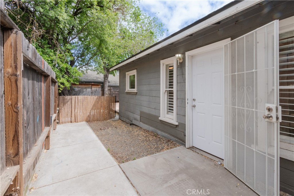 415 7th Street Paso Robles, CA 93446 - Photo 18 of 21 a backyard of a house with wooden fence and large trees