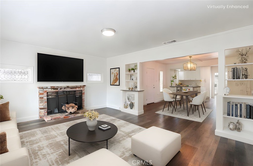415 7th Street Paso Robles, CA 93446 - Photo 3 of 21 a living room with furniture a fireplace and a flat screen tv