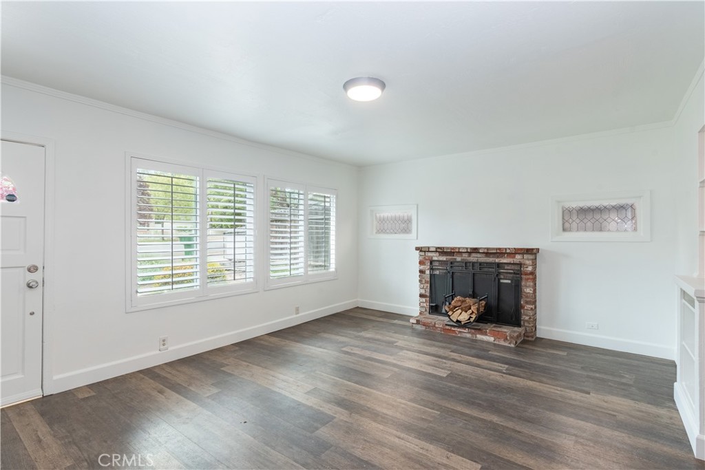 415 7th Street Paso Robles, CA 93446 - Photo 6 of 21 a living room with a fireplace and a table