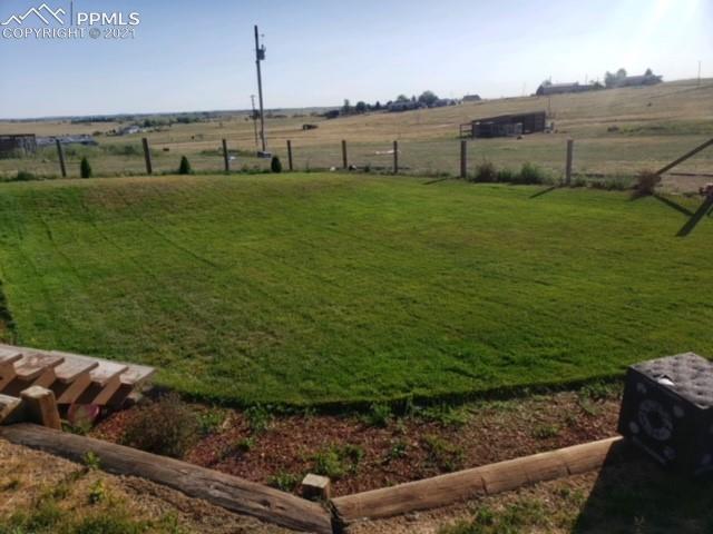 3225 Hoofprint Road Peyton, CO 80831 - Photo 46 of 46 Landscaped area in backyard with sprinkler system