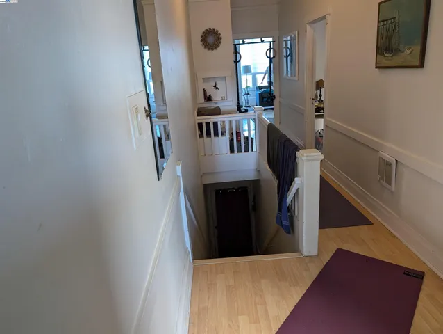 a view of entryway and hall with wooden floor