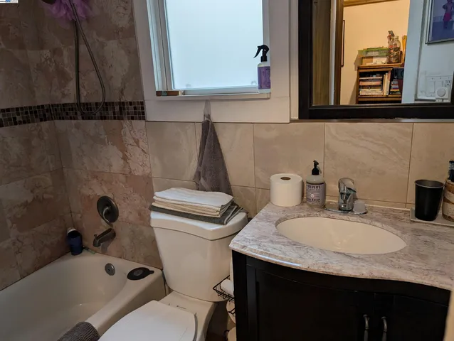a bathroom with a sink a toilet and bathtub