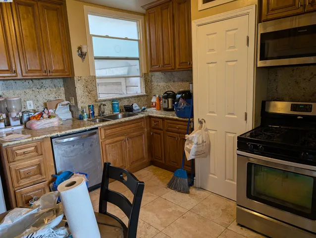 a kitchen with a sink appliances and cabinets