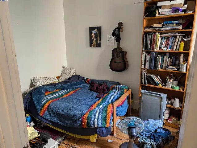 a bed room with a bed and a book shelf