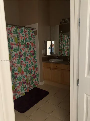 a bathroom with a bathtub and a shower curtain