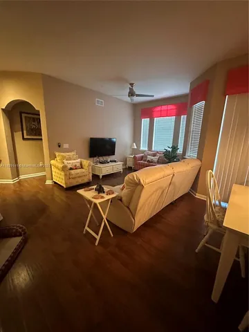 a bedroom with furniture and wooden floor