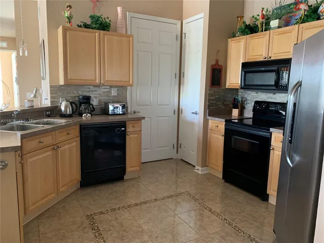 a kitchen with a sink stove and refrigerator