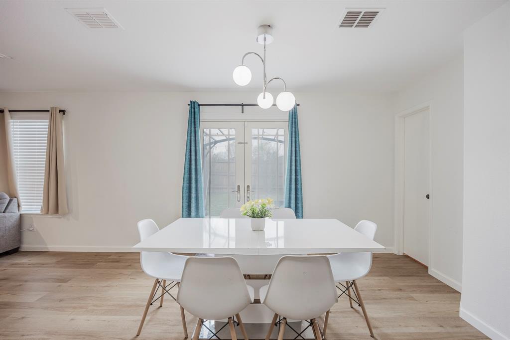 7935 Faithful Trail Dallas, TX 75237 - Photo 15 of 38 a view of a dining room with furniture and wooden floor