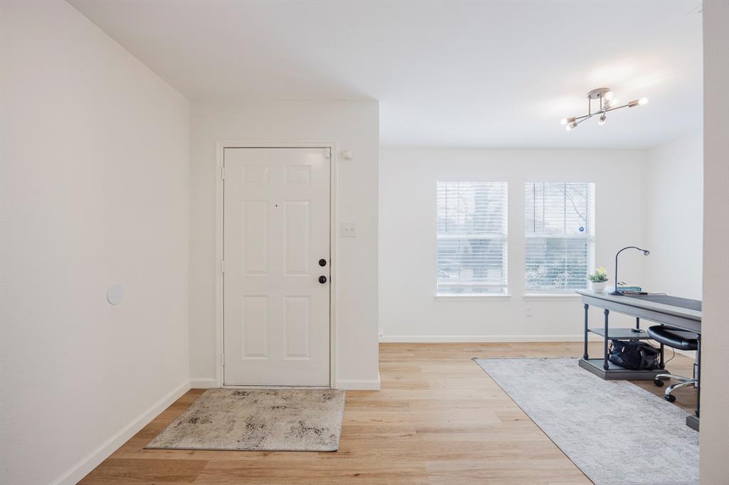 7935 Faithful Trail Dallas, TX 75237 - Photo 2 of 38 Foyer entrance featuring light wood-style floors and baseboards