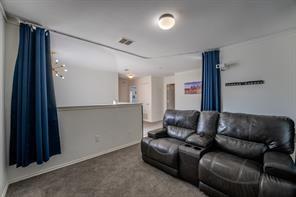 7935 Faithful Trail Dallas, TX 75237 - Photo 29 of 38 a living room with a couch and a refrigerator