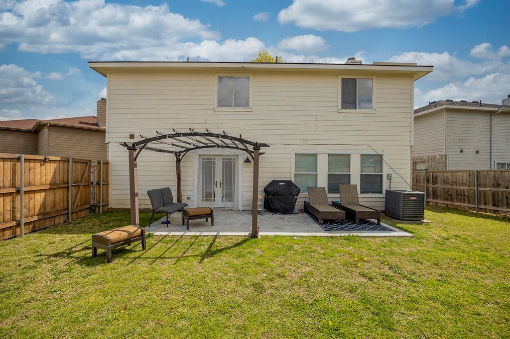 7935 Faithful Trail Dallas, TX 75237 - Photo 33 of 38 a view of a patio with table and chairs under an umbrella