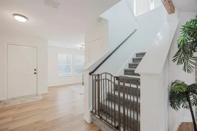 a view of entryway with wooden floor and stairs