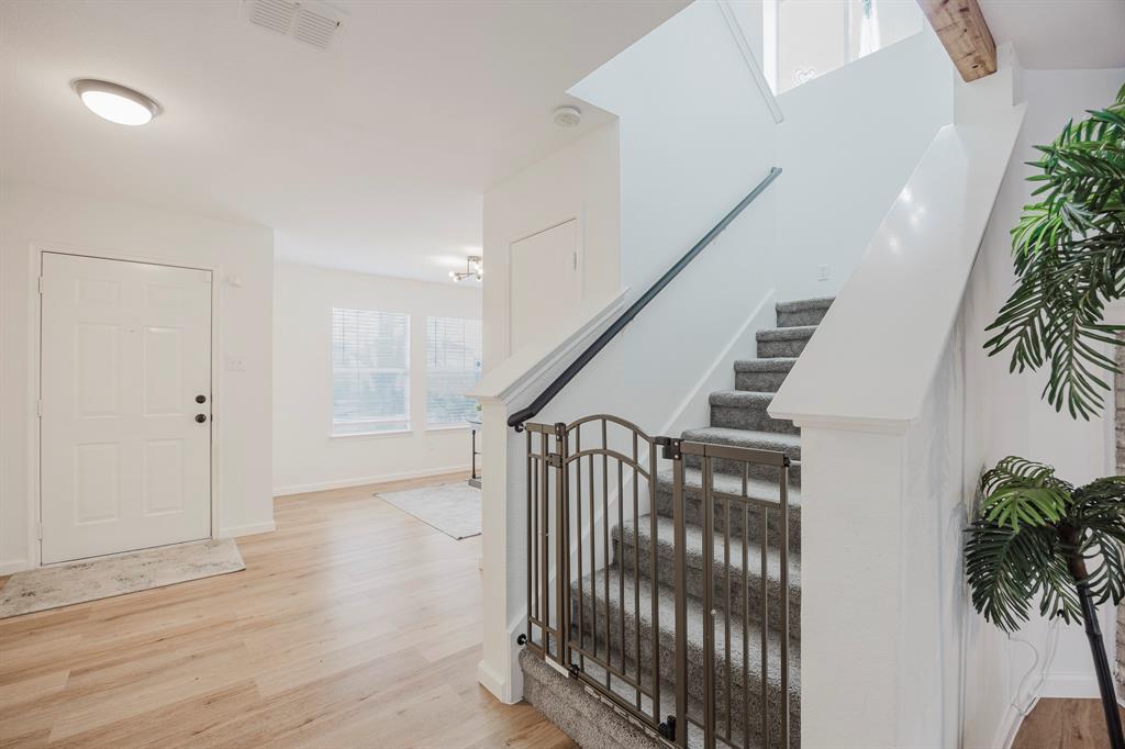 7935 Faithful Trail Dallas, TX 75237 - Photo 6 of 38 a view of entryway with wooden floor and stairs