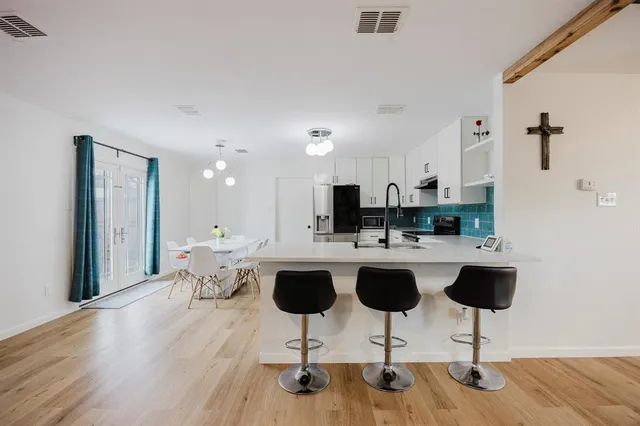 a living room with lots of furniture and a chandelier