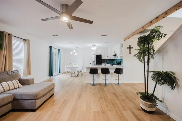 a living room with furniture and a potted plant