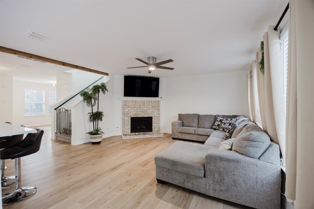 7935 Faithful Trail Dallas, TX 75237 - Photo 10 of 38 a living room with furniture and a fireplace