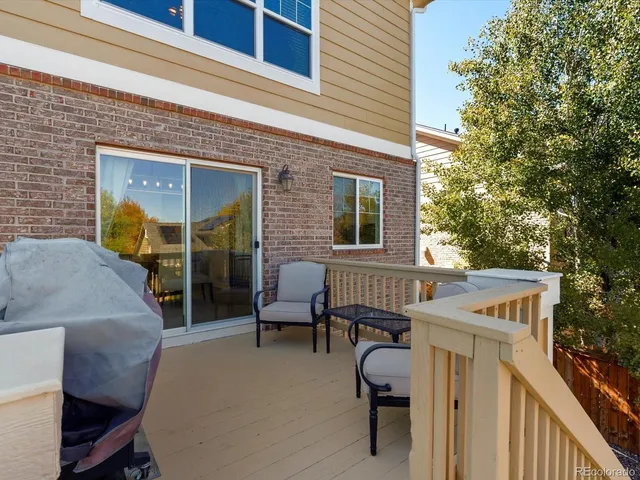 a view of a house with a patio and a yard