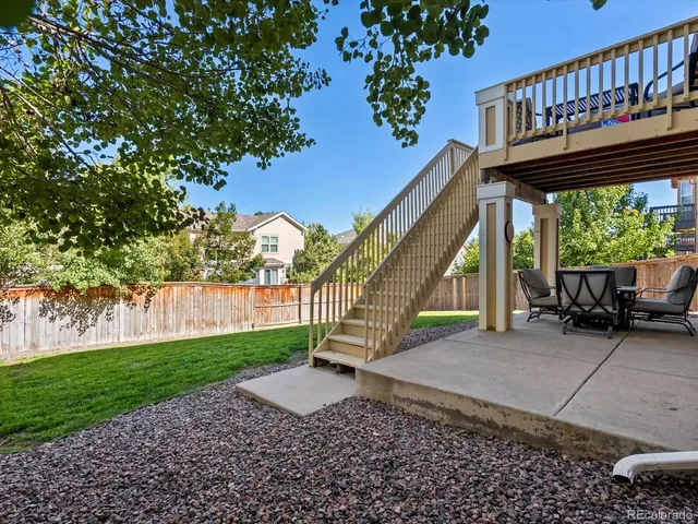 a view of a house with backyard and sitting area